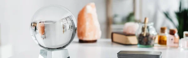 Glass orb near tarot cards on table, banner — Stock Photo