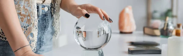 Cropped view of medium touching orb near cards and candles on table, banner — Stock Photo