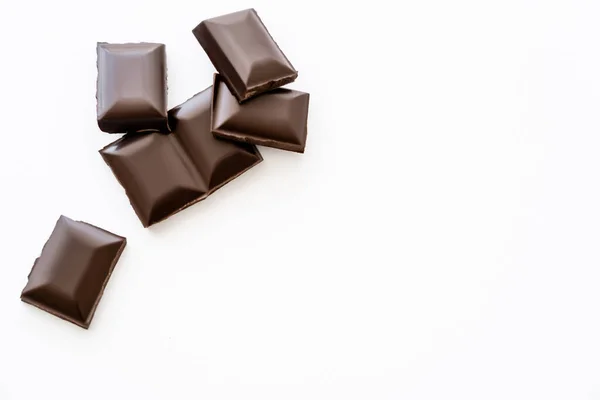 Top view of chocolate pieces on white background with copy space — Stock Photo