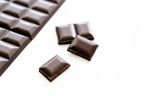 Close up view of dark chocolate on white background — Photo de stock