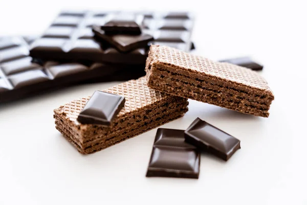 Close up view of waffles and dark chocolate on white background — стоковое фото