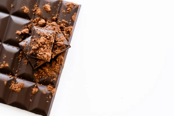 Top view of cocoa powder on dark chocolate on white background — Stockfoto