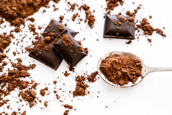 Top view of cocoa in spoon near chocolate on white background — Photo de stock