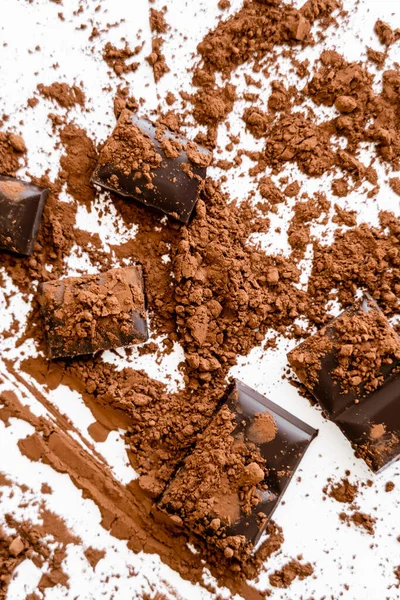 Top view of natural cocoa powder on chocolate on white background — Stockfoto