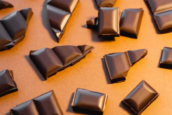 Top view of natural dark chocolate on brown background — Stock Photo