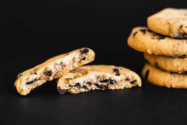 Close up view of tasty cookies with chocolate chips on black background — стоковое фото