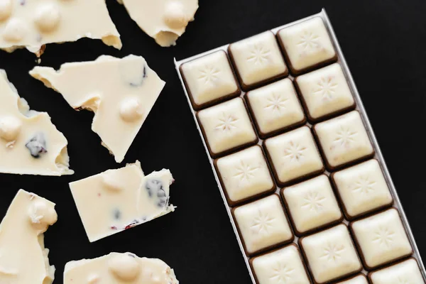 Top view of tasty white chocolate on black background — Foto stock