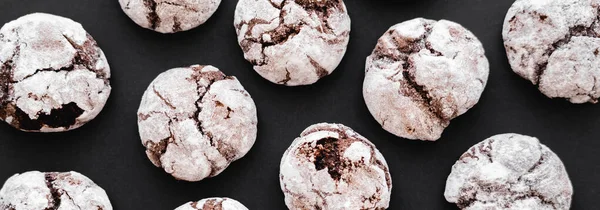 Top view of tasty biscuits with powdered sugar on black background, banner — Stock Photo