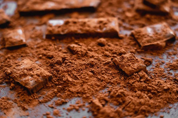 Close up view of natural dry cocoa and chocolate on black background — Stockfoto