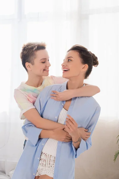 Pessoas grandes alegres abraçando e sorrindo um para o outro em casa — Fotografia de Stock