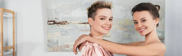 Young and cheerful pangender partners looking at camera, banner — Photo de stock