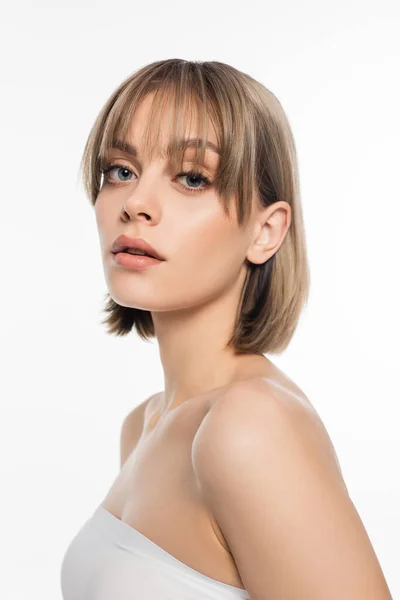 Young woman with bare shoulders looking at camera isolated on white — Stock Photo