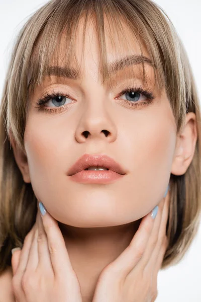 Close up of woman with blue eyes looking at camera isolated on white — Stock Photo