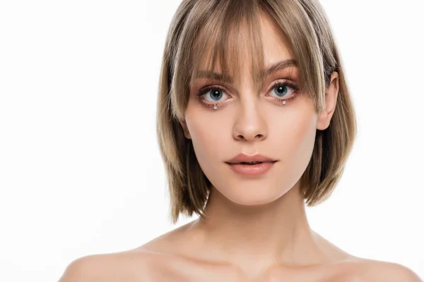 Pretty young woman with bangs and decorative rhinestones under blue eyes isolated on white — Photo de stock