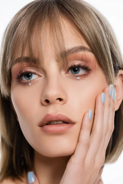 Pretty young woman with makeup and shiny rhinestones under blue eyes isolated on white — Foto stock