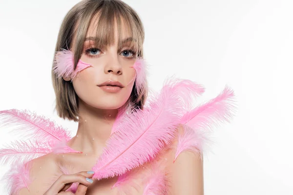 Pretty woman with decorative beads on neck and body holding pink feathers isolated on white — Foto stock