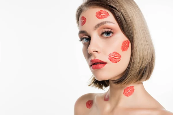 Red kiss prints on cheeks and body of pretty young woman isolated on white — Stockfoto