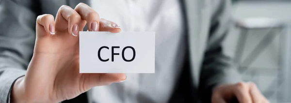 Vista ritagliata della donna che tiene carta con iscrizione in cfo in ufficio, banner — Foto stock