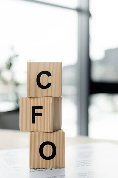 Close up of wooden cubes with cfo letters on desk — Stock Photo