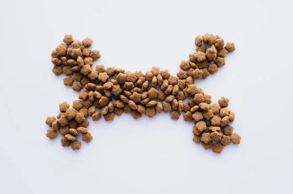 Top view of bone shape made of dry pet food isolated on white — Stock Photo