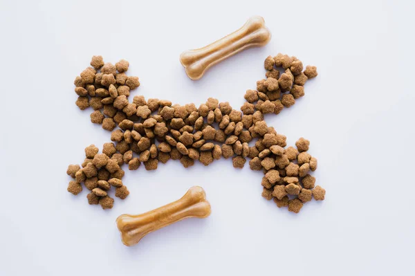 Top view of bones and dry pet food isolated on white — Stock Photo