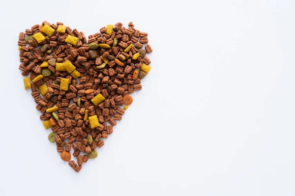 Top view of heart made of crunchy dry pet food isolated on white — Stock Photo