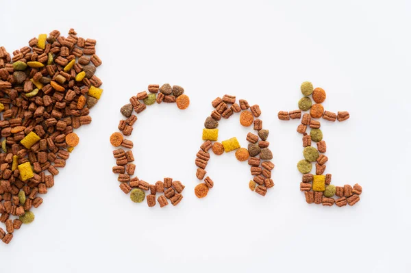 Top view of heart and cat word made of dry pet food isolated on white — Stock Photo