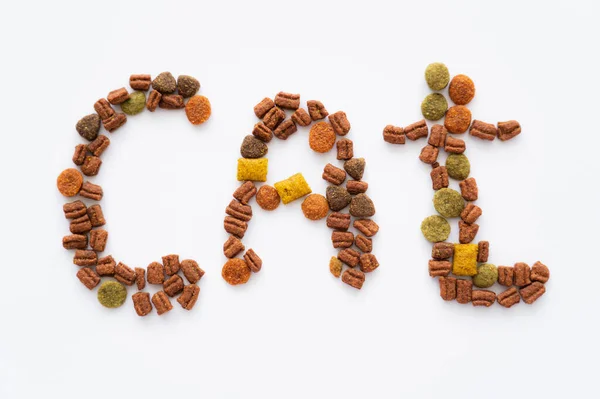 Top view of cat word made of dry pet food isolated on white — Stock Photo