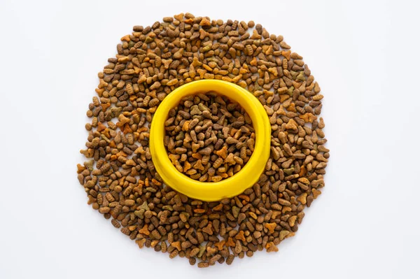 Top view of cat food in yellow bowl isolated on white with copy space — Stock Photo