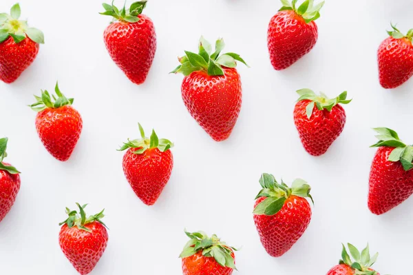Flat lay with ripe strawberries on white background — Stock Photo