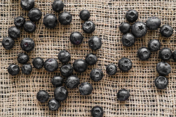Top view of whole blueberries on sackcloth — Stock Photo
