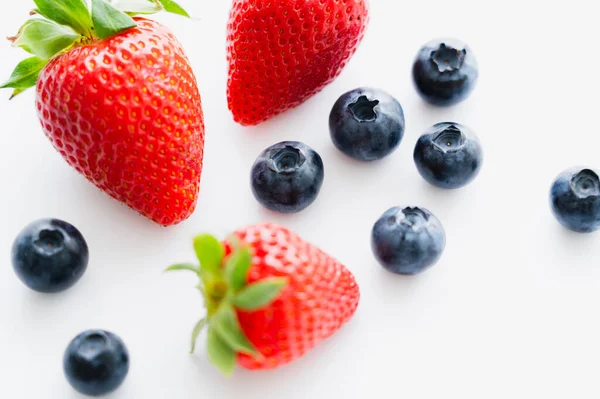 Close up view of organic berries on white surface — Stock Photo