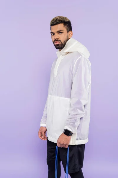 Young african american man in trendy sportswear isolated on purple — Stock Photo