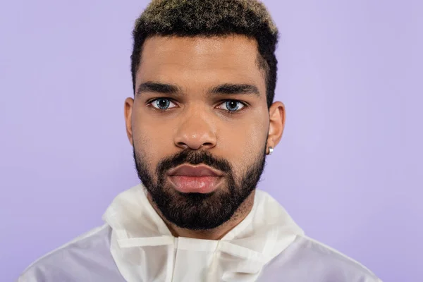 Portrait of bearded african american man with blue eyes isolated on purple — Stock Photo