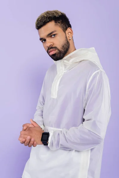 Young african american sportsman with smart watch posing with clenched hands isolated on purple — Stock Photo