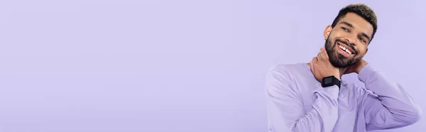 Bearded african american man in sweater smiling isolated on purple, banner — Stock Photo