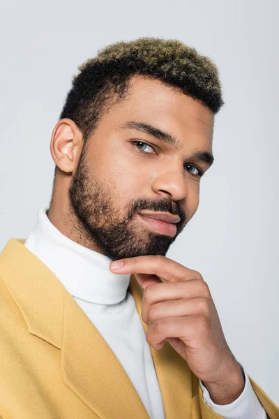 Portrait of african american man with blue eyes in stylish outfit isolated on grey — Stock Photo