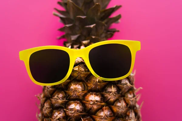 Top view of sunglasses on pineapple isolated on pink — Stock Photo