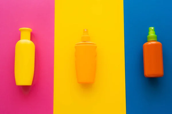 Top view of sunscreens on colorful background — Stock Photo
