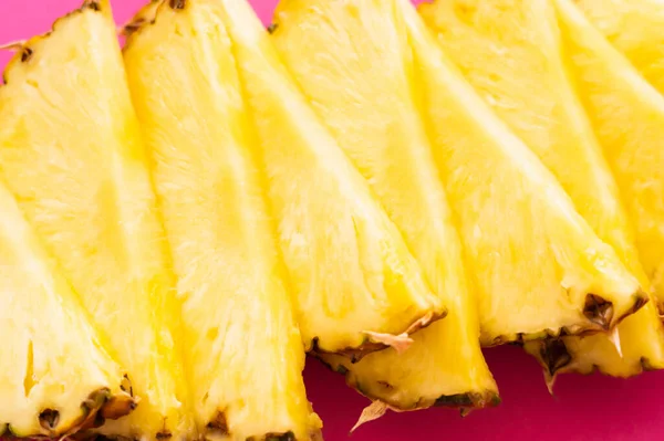 Close up view of cut fresh pineapple on pink surface — Stock Photo