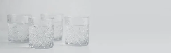 Transparent glasses with pure water on grey background, banner — Stock Photo