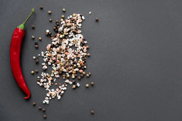 Top view of spices and chili pepper on black background — Stock Photo