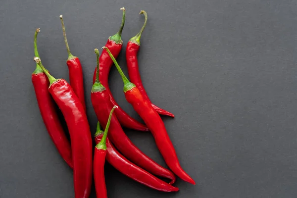 Top view of ripe chili peppers on black background — Stock Photo