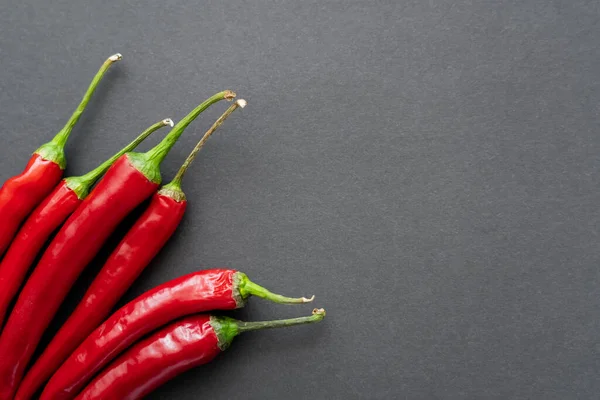 Top view of red ripe chili peppers on black background — Stock Photo