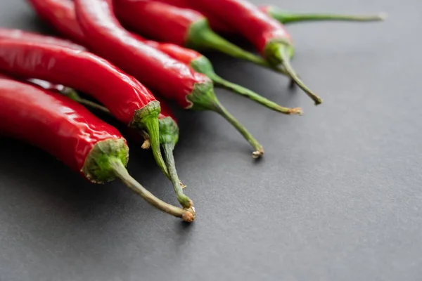 Close up view of chili peppers on black background — Stock Photo