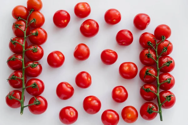 Top view of organic cherry tomatoes on branches on white background — Stock Photo