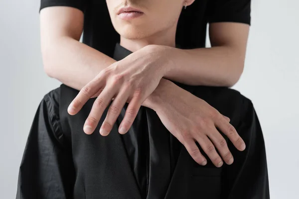 Vue recadrée de l'homme étreignant petit ami isolé sur gris — Photo de stock