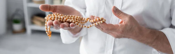 Partial view of guru man holding mala beads, banner — Stock Photo