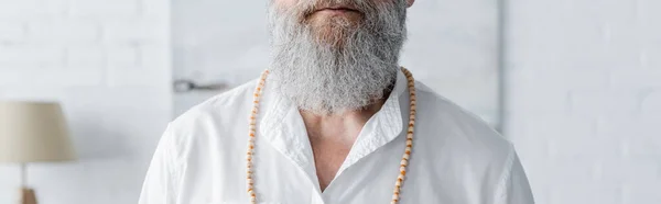 Partial view of spiritual mentor in white shirt and beads, banner — Stock Photo