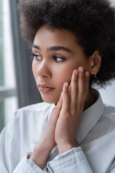 Portrait of worried african american woman looking away at home — Stock Photo